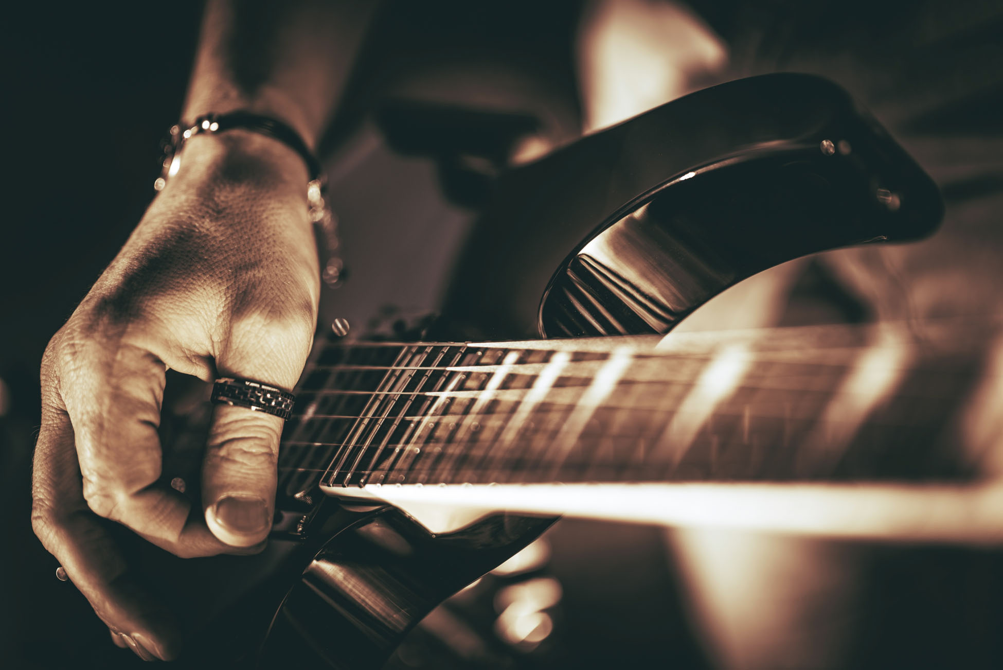 Guitarist Plays. Electric Guitar Playing Closeup Photo. Rockman Guitar Player Music Theme.